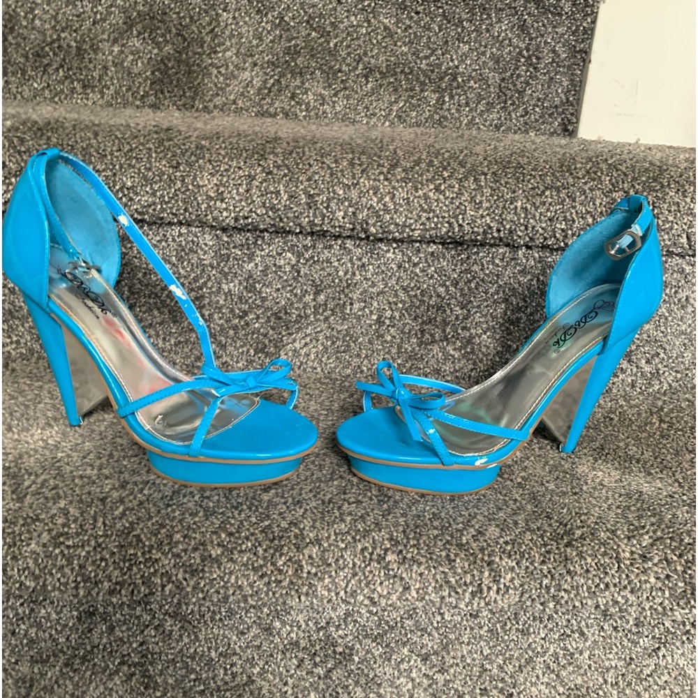 Beautiful turquoise DKDB fashion 8 1/2 inch open toe heels. Slightly used.
